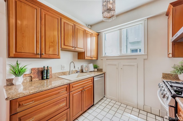 kitchen with dishwasher, gas range, sink, light stone countertops, and light tile patterned flooring