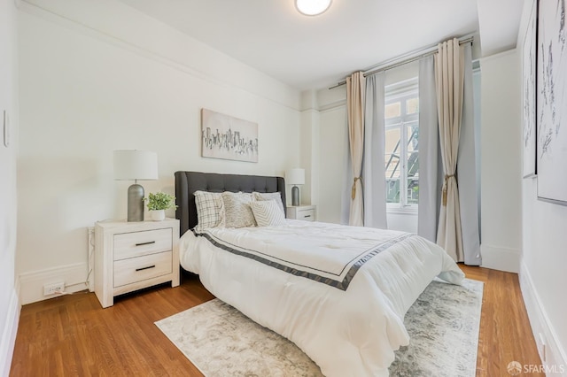 bedroom with wood-type flooring