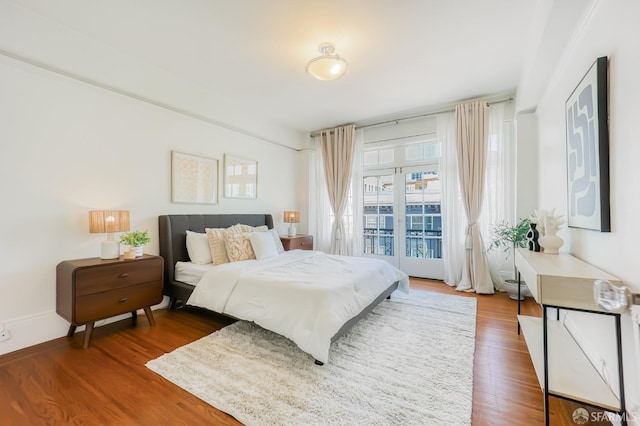 bedroom featuring hardwood / wood-style floors and access to exterior