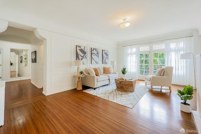 living room featuring french doors and hardwood / wood-style flooring