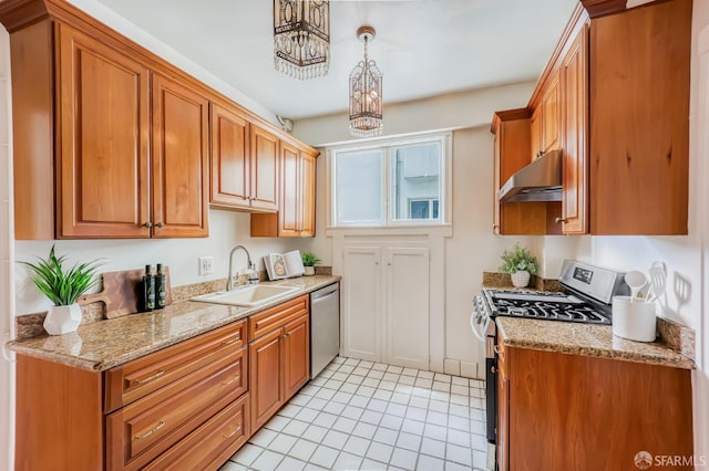 kitchen featuring light stone counters, a chandelier, sink, pendant lighting, and stainless steel appliances