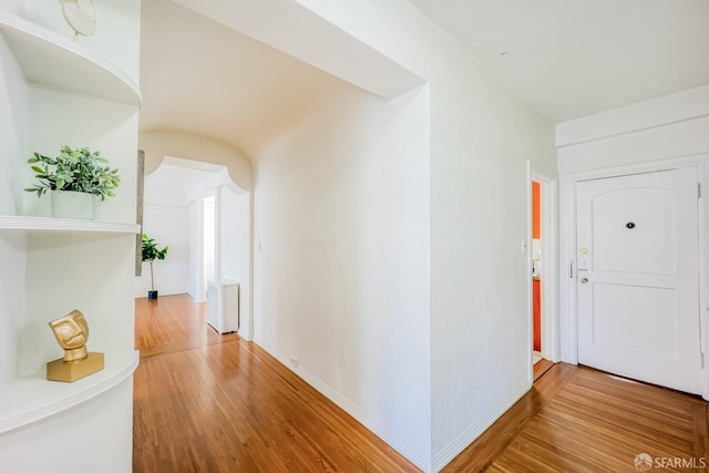 corridor featuring hardwood / wood-style floors