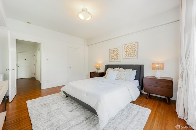 bedroom with hardwood / wood-style flooring