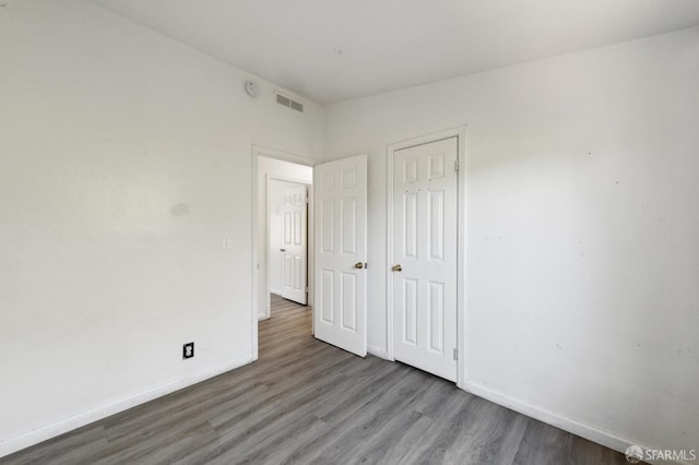 unfurnished bedroom featuring hardwood / wood-style flooring