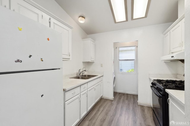 kitchen featuring white cabinetry, gas stove, white refrigerator, light hardwood / wood-style flooring, and sink