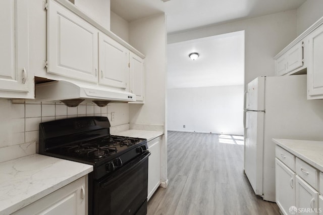 kitchen featuring white fridge, white cabinets, black gas stove, and light wood-type flooring