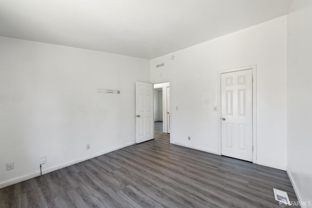 unfurnished bedroom with dark wood-type flooring