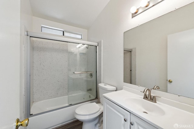 full bathroom featuring toilet, vanity, and bath / shower combo with glass door