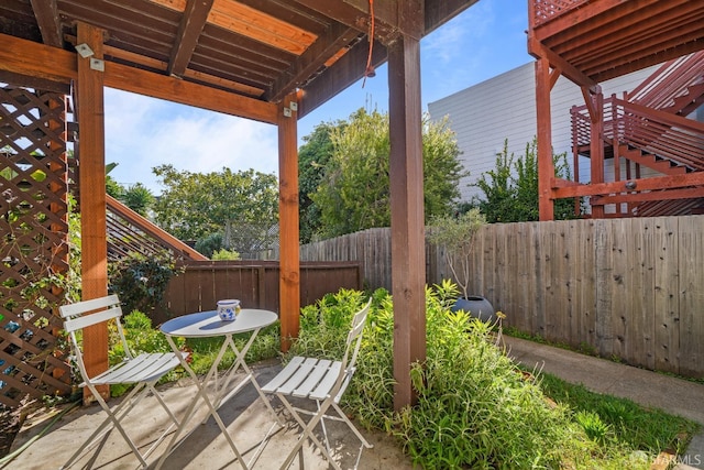 view of patio / terrace featuring fence