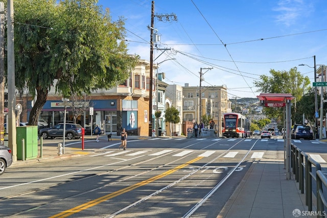 view of street featuring sidewalks, street lighting, and curbs