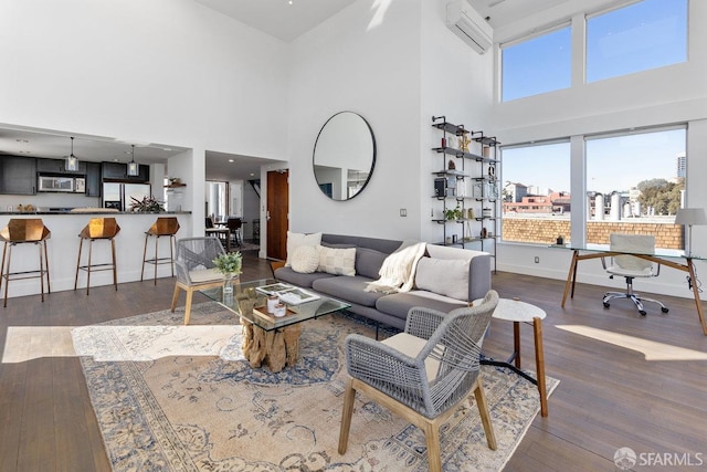 living room with hardwood / wood-style flooring and a wall mounted air conditioner