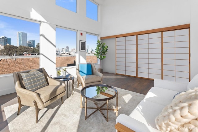 living room featuring hardwood / wood-style flooring and a high ceiling