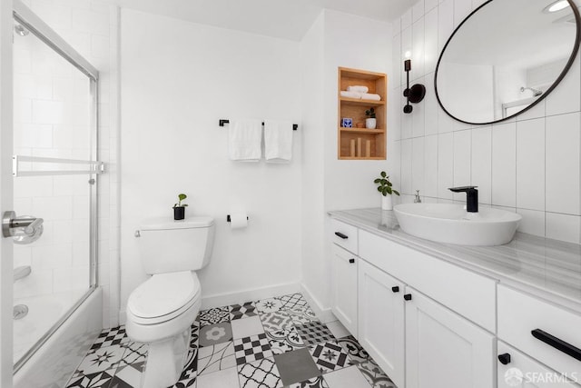 full bathroom with toilet, vanity, shower / bath combination with glass door, and tile walls