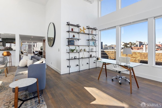 office with a high ceiling and dark hardwood / wood-style floors