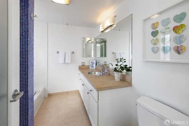 full bathroom featuring vanity, tiled shower / bath combo, tile patterned floors, and toilet