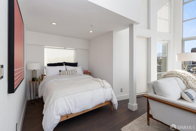 bedroom with dark wood-type flooring