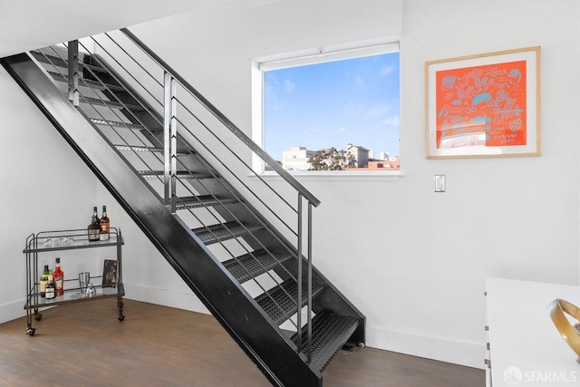 stairs featuring hardwood / wood-style floors