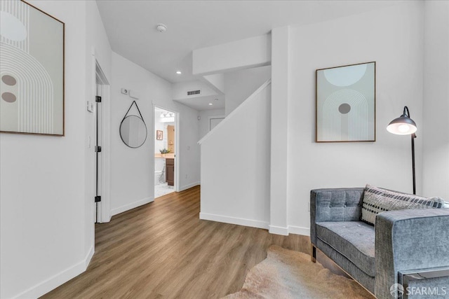 114 Emerald Cove Ter, San Francisco, CA 94134 - sitting room featuring wood finished floors, baseboards, recessed lighting, and stairs