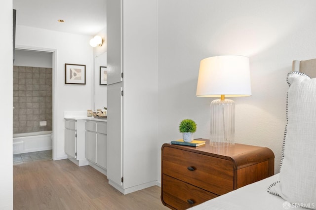 389 Belmont St Unit 306, Oakland, CA 94610 - bedroom with light wood-type flooring and connected bathroom