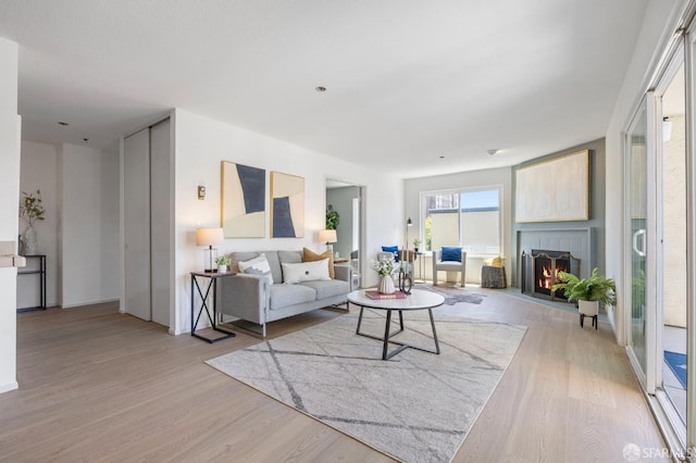 389 Belmont St Unit 306, Oakland, CA 94610 - living room with light wood-style flooring and a brick fireplace