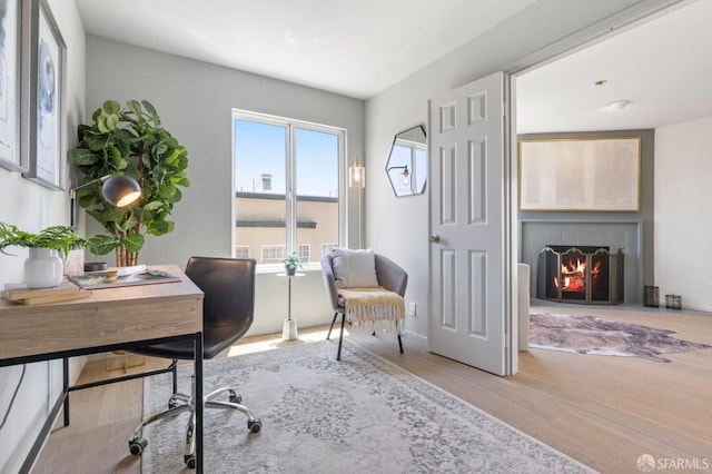 389 Belmont St Unit 306, Oakland, CA 94610 - office area with wood finished floors and a lit fireplace