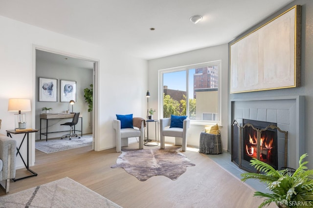 389 Belmont St Unit 306, Oakland, CA 94610 - living area featuring light wood-type flooring and a brick fireplace