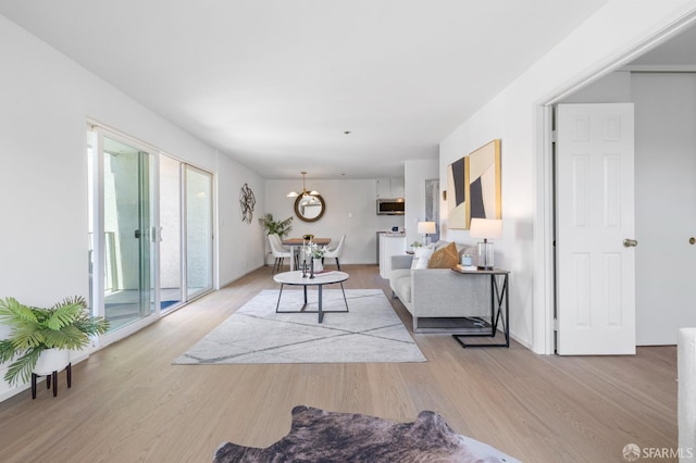 389 Belmont St Unit 306, Oakland, CA 94610 - living room featuring wood finished floors and a chandelier