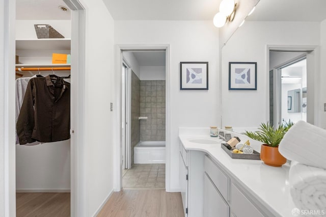 389 Belmont St Unit 306, Oakland, CA 94610 - bathroom featuring vanity, wood finished floors, and a walk in closet
