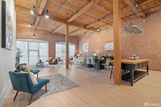 355 Bryant St Unit 411, San Francisco, CA 94107 - living room featuring brick wall, a wooden ceiling with exposed beams, and wood finished floors
