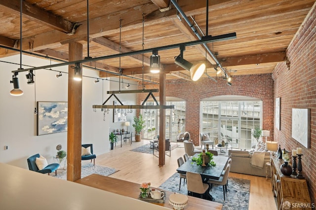 355 Bryant St Unit 411, San Francisco, CA 94107 - dining space with brick wall, a wooden ceiling with exposed beams, and wood finished floors