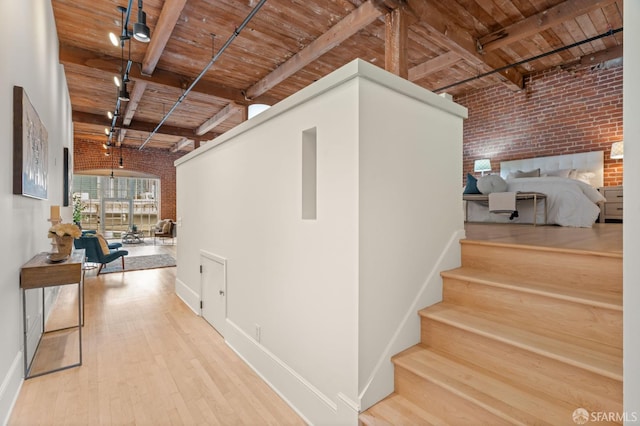 355 Bryant St Unit 411, San Francisco, CA 94107 - stairs featuring brick wall, a wooden ceiling with exposed beams, wood finished floors, and track lighting