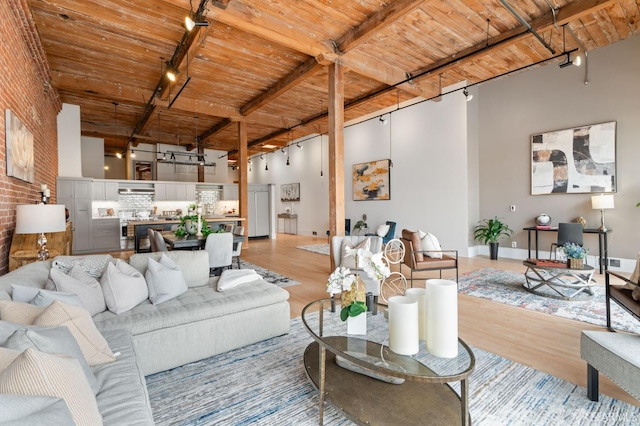 355 Bryant St Unit 411, San Francisco, CA 94107 - living room with track lighting, a wood ceiling with exposed beams, light wood-style flooring, and a towering ceiling