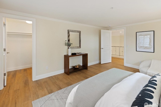 110 Sheridan Rd, Oakland, CA 94618 - bedroom with a walk in closet, wood finished floors, ornamental molding, baseboards, and a closet