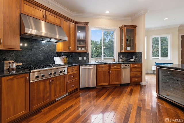 110 Sheridan Rd, Oakland, CA 94618 - kitchen featuring under cabinet range hood, stainless steel appliances, dark wood finished floors, brown cabinets, and crown molding