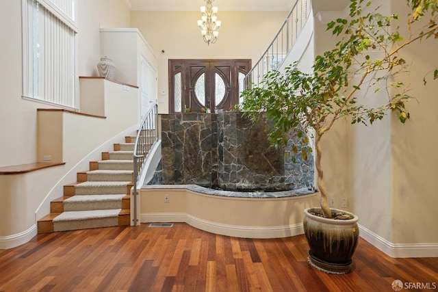 110 Sheridan Rd, Oakland, CA 94618 - foyer entrance with stairway, a chandelier, wood finished floors, baseboards, and crown molding