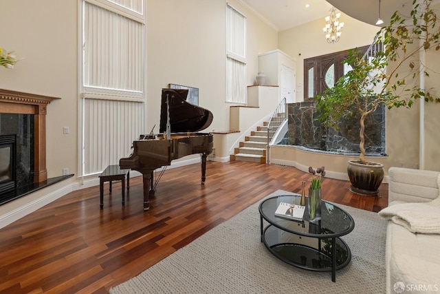 110 Sheridan Rd, Oakland, CA 94618 - living room with wood finished floors, a chandelier, baseboards, a high end fireplace, and healthy amount of natural light