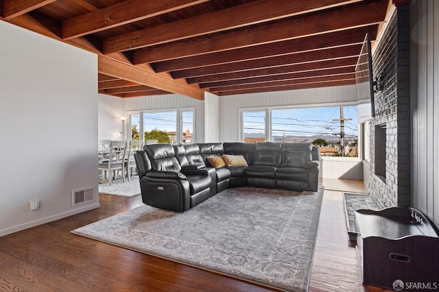 living room with beamed ceiling and hardwood / wood-style floors