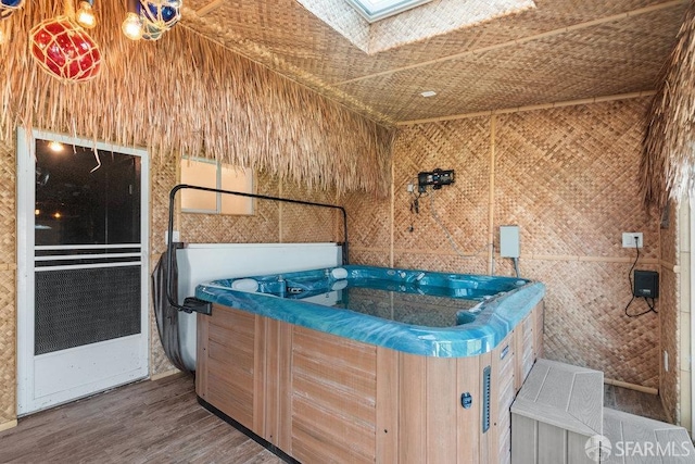 miscellaneous room featuring a jacuzzi and dark hardwood / wood-style floors