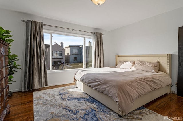 bedroom with dark hardwood / wood-style floors