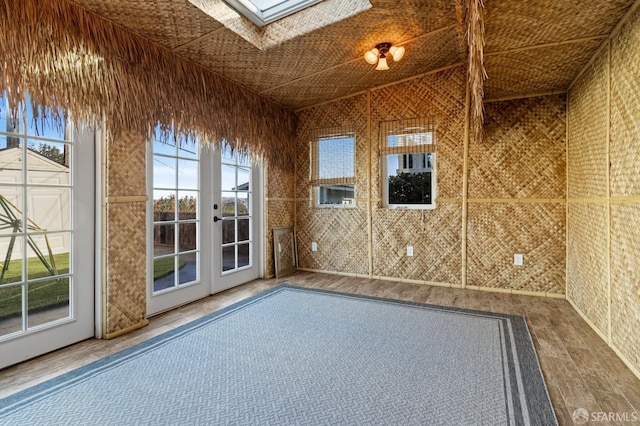 unfurnished room with french doors and a skylight