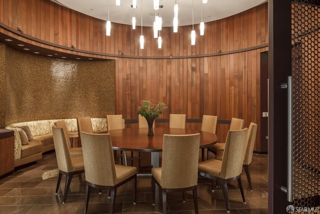 dining room featuring wood walls