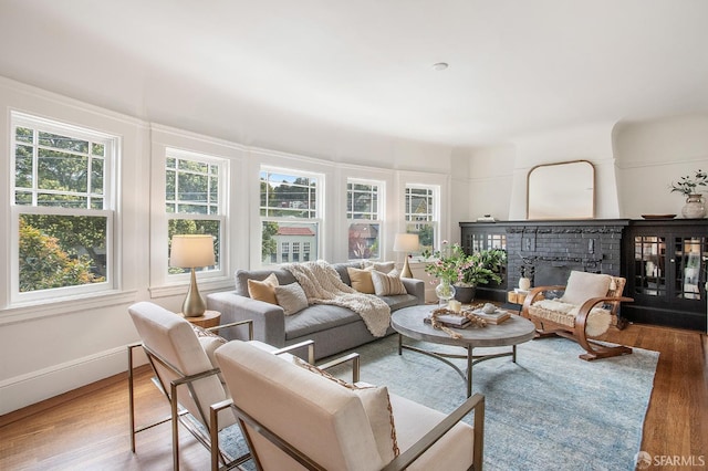 sunroom / solarium featuring a brick fireplace