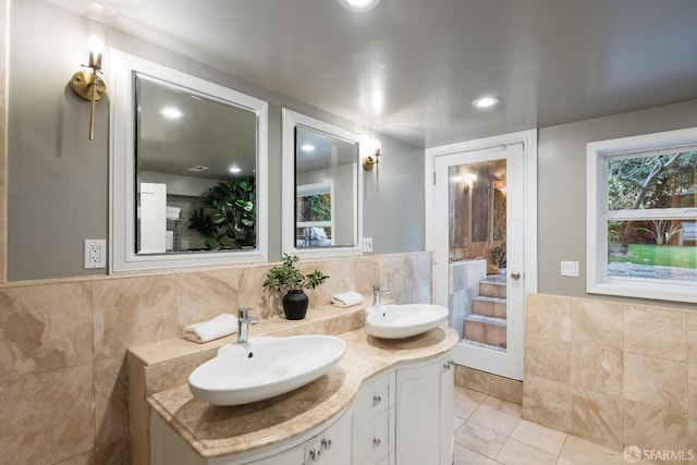 bathroom featuring tile walls, vanity, and tile patterned flooring