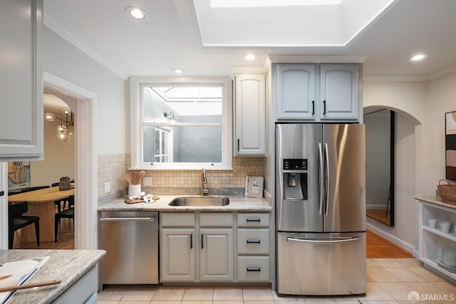 kitchen featuring gray cabinetry, sink, tasteful backsplash, and stainless steel appliances