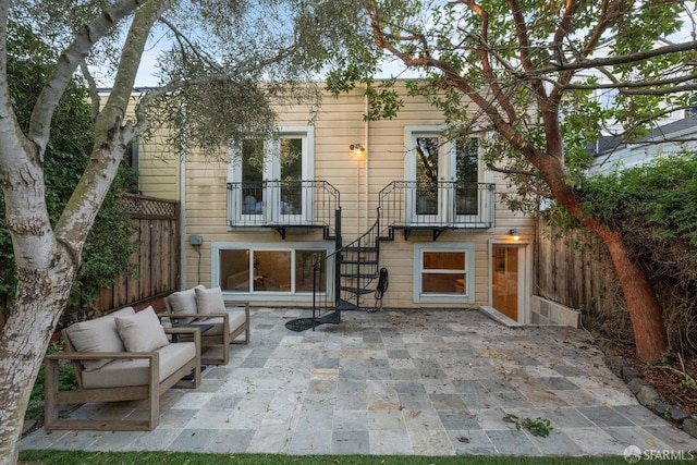 rear view of property with a patio area and outdoor lounge area