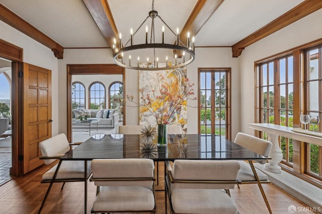 dining area with an inviting chandelier and beam ceiling