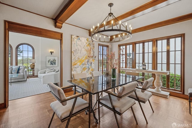 dining room with a notable chandelier, baseboards, and beamed ceiling