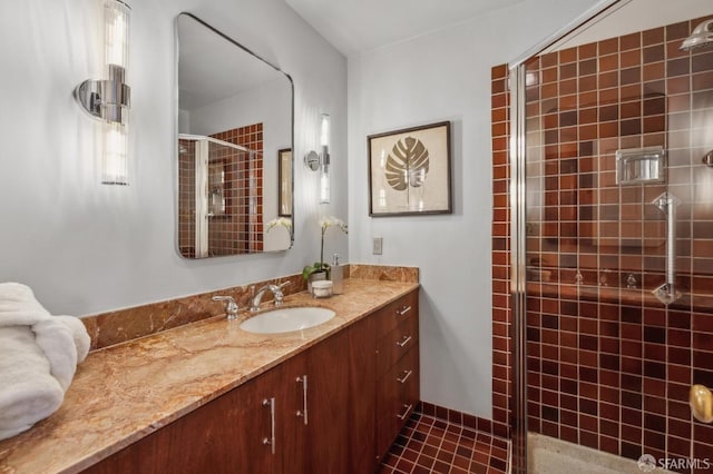 bathroom featuring a shower stall and vanity