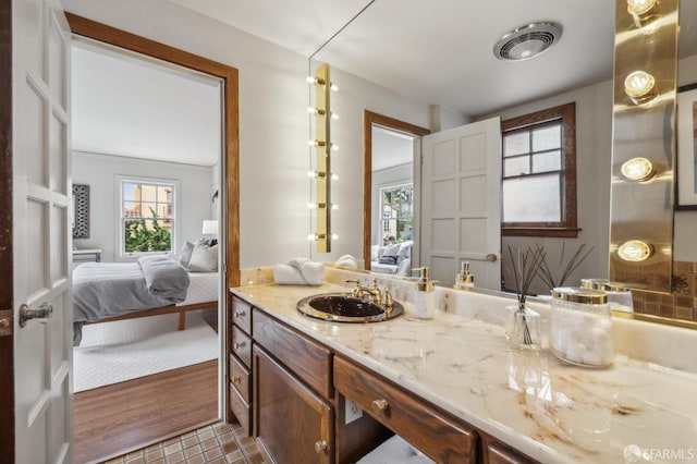 ensuite bathroom with vanity, ensuite bathroom, visible vents, and tile patterned floors