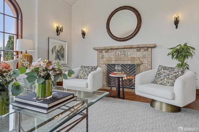 living area with a lit fireplace and vaulted ceiling
